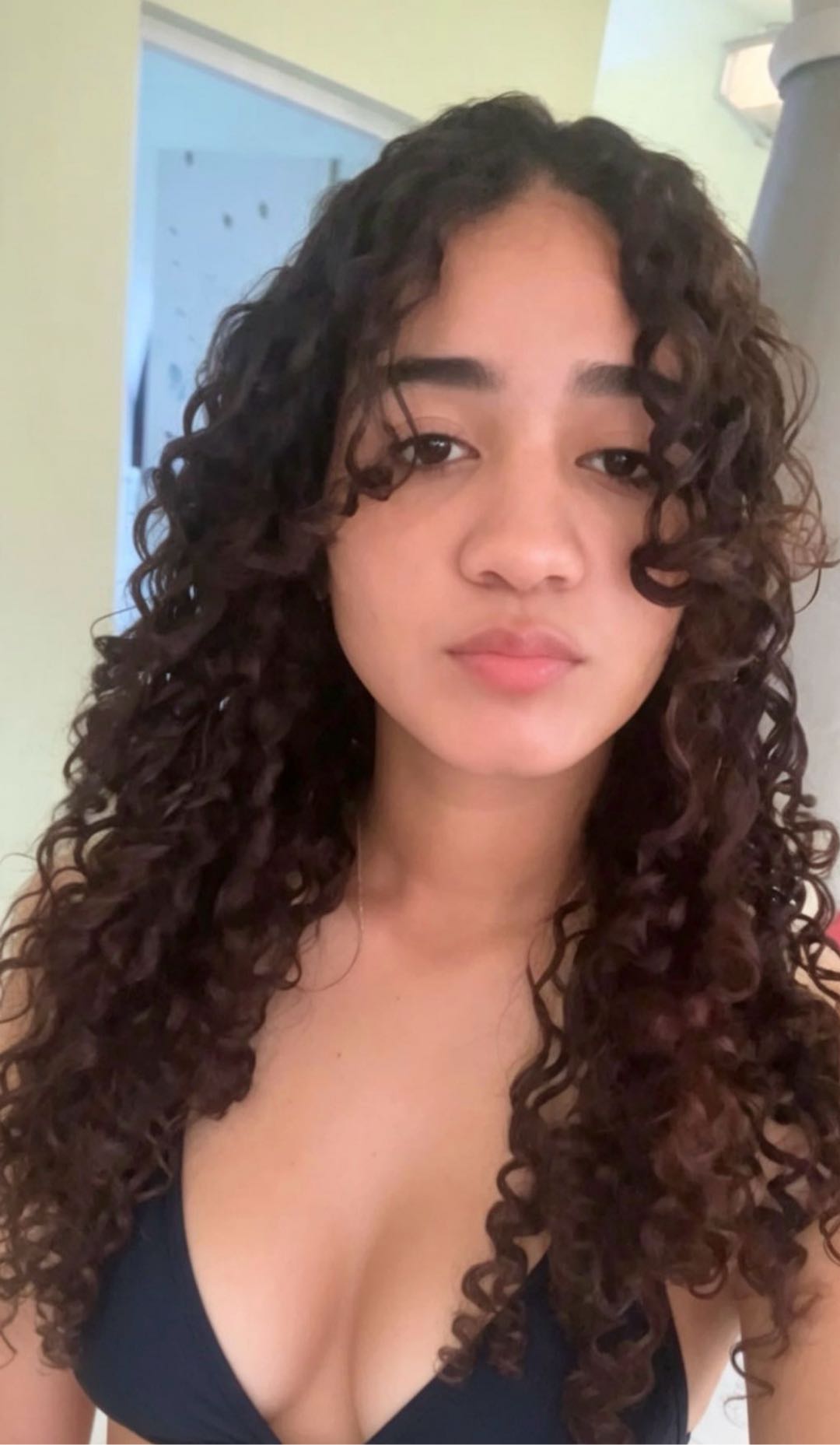 A close-up portrait of a girl with curly hair