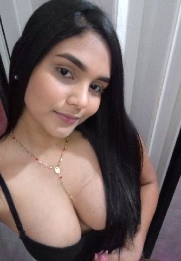 A girl with long dark hair looking at the camera