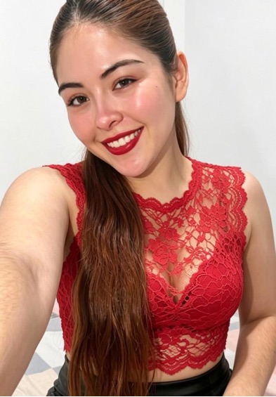 A smiling girl in a red lace top