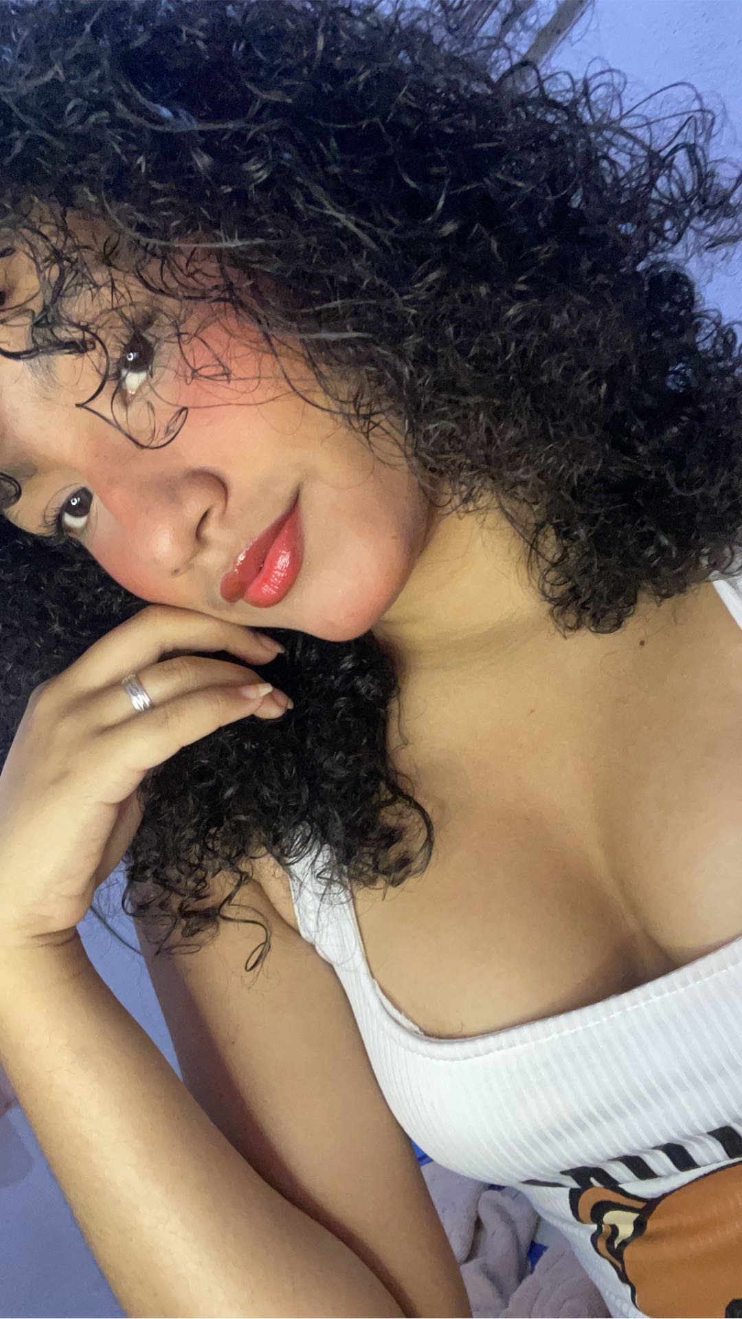 A girl with curly hair and glasses in a private call